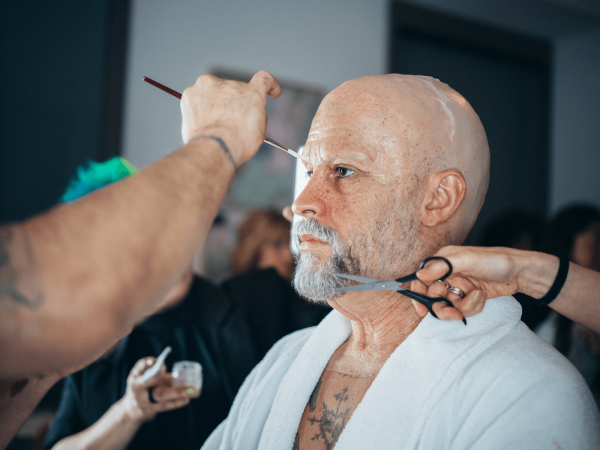 Bad Bunny in the makeup chair having prosthetics applied on him to make him look older for the 2026 Met Gala.